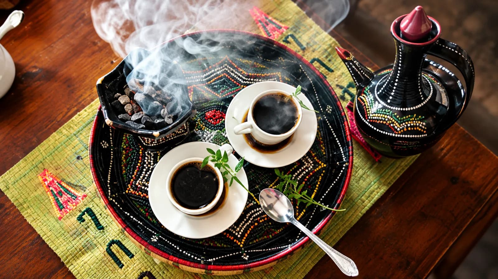 Green coffee beans roasting over coals during an Ethiopian coffee ceremony
