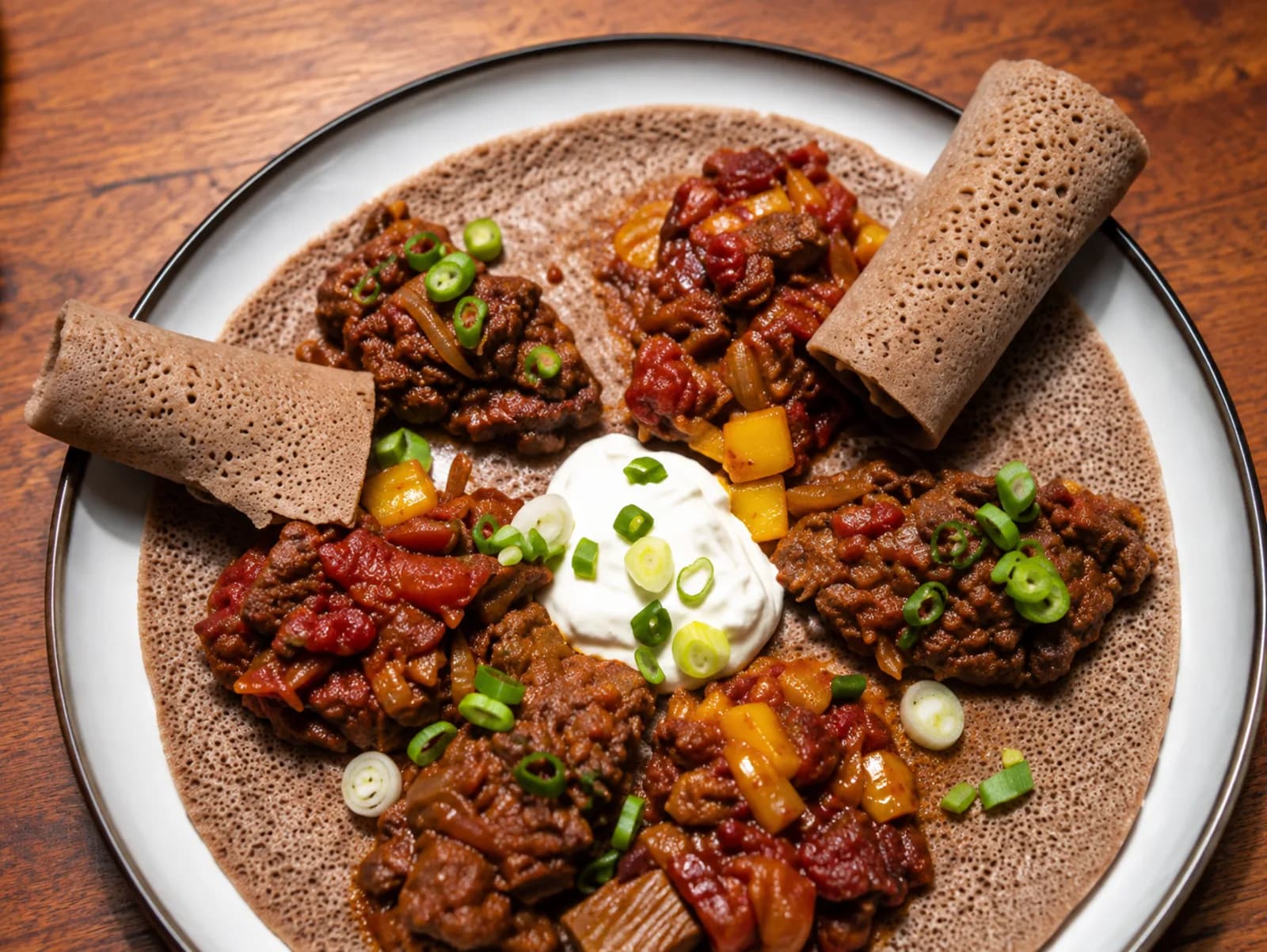 Pour injera in a family kitchen